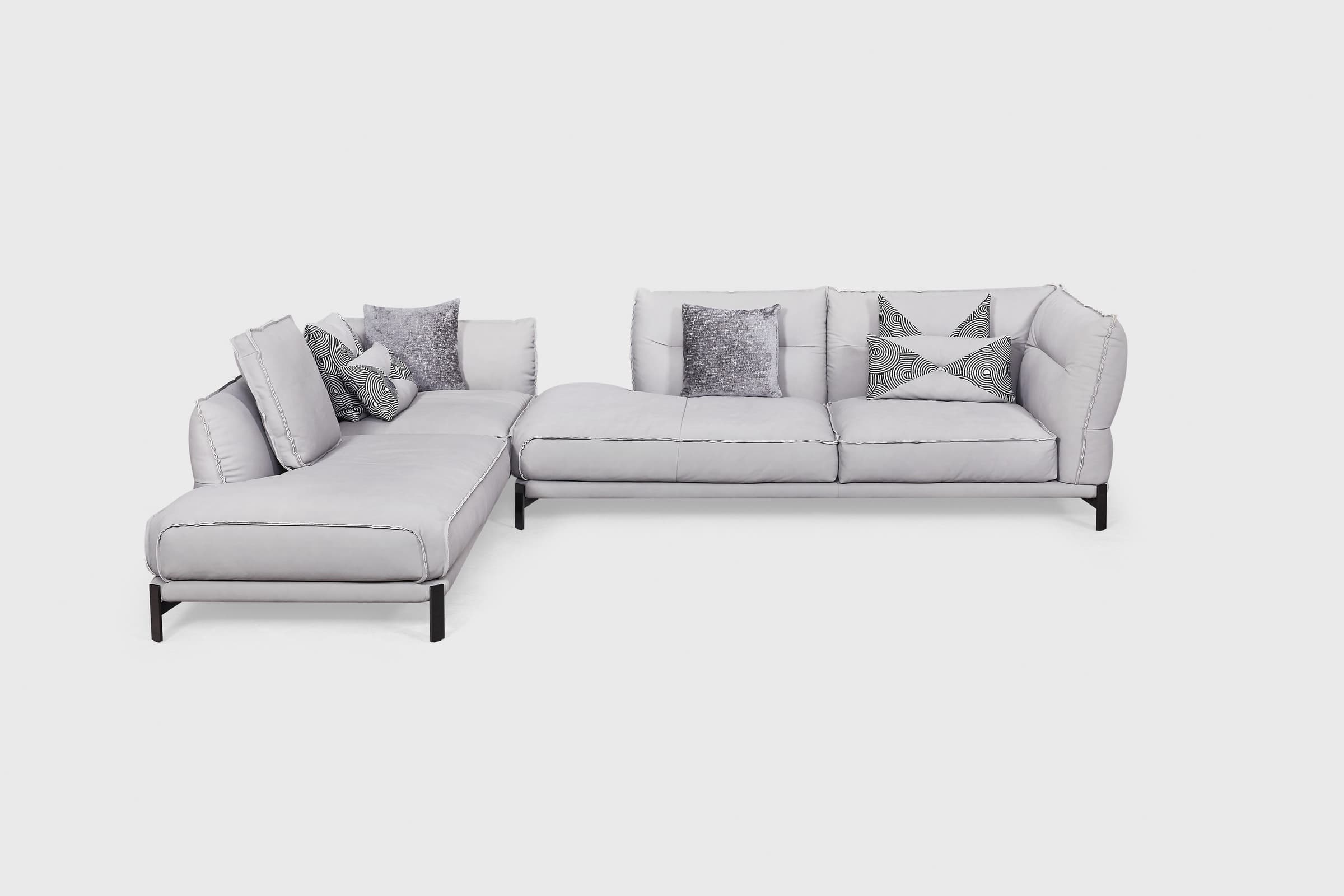 Gota grey L-shaped sectional with open corner platform, edge-stitched cushions and patterned monochrome pillows